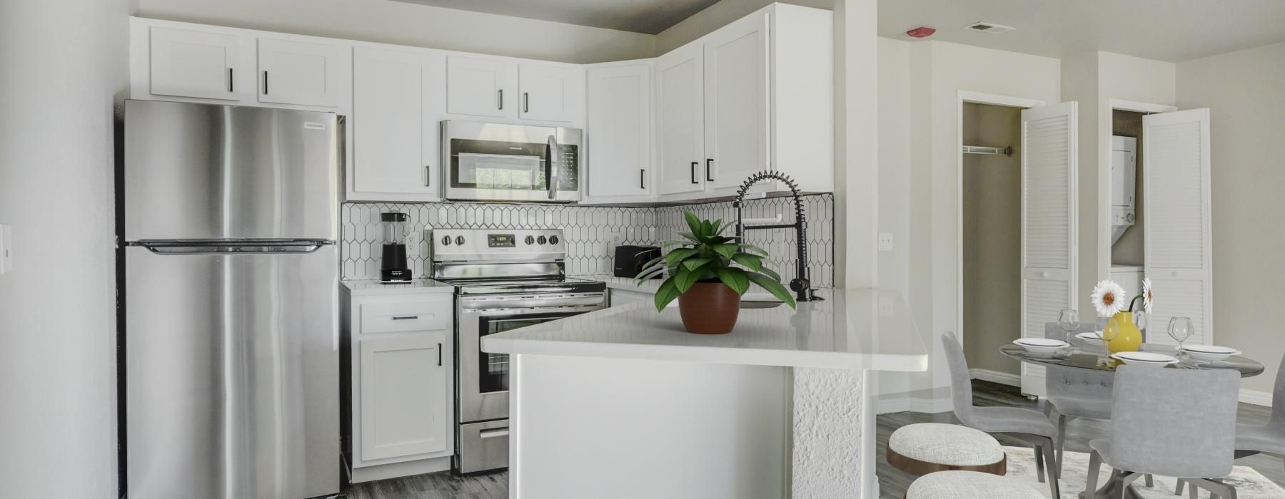 a kitchen with white cabinets