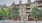 a building with trees and bushes in front of it