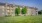 a large building with a lawn in front of it